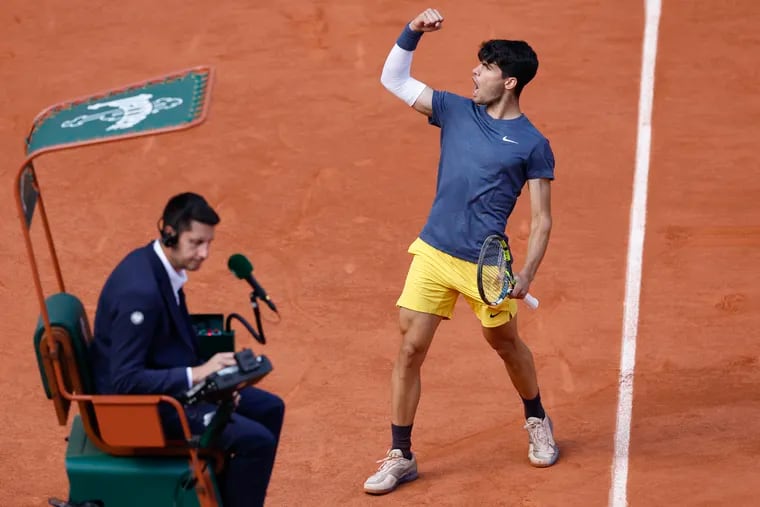 Spain's Carlos Alcaraz celebrates next to chair umpire Renaud Lichtenstein after scoring against Germany's Alexander Zverev during the men's final of the French Open.
