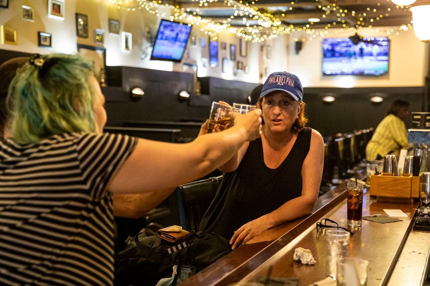 Shelly McRedmond (right), who was visiting from Idaho, raises a toast to Sean and Kaytlin Wiley of Montgomery County, at Craftsman Row Saloon in Center City. They were celebrating Kaytlin’s birthday.