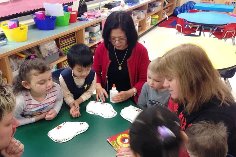 In this Feb. 19, 2015 photo, from left, Skyler Demars, Kevin Hu, Mandarin teacher Shwu-Ching Wang, Hunter Hatch and kindergarten teacher Lisa Halloran decorate sheep in honor of the Lunar New Year at the Mohegan Elementary School in Montville, Conn. At Connecticutâ€™s casinos, the staff can speak to you in nearly any Asian language. The diversity of the workforce at the casinos, which cater heavily to Asian gamblers from New York, is changing the complexion of nearby public schools that have been hiring more language specialists and adding new cultural traditions. (AP Photo/Michael Melia)