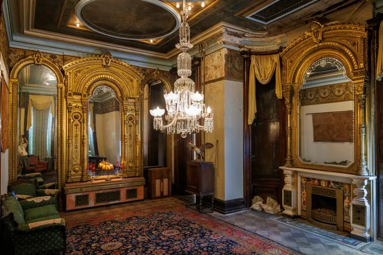 An ornate first-floor room with a chandelier is shown in a historic North Philadelphia mansion that Father Divine's Peace Mission is putting up for auction on Aug. 28.