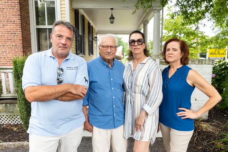 (From left) Gary Ell, a trustee of the Historical Society of Moorestown; Lenny Wagner, society president; Julie Maravich, president of the advocacy group Saving Historic Moorestown; and township council member Sue Mammarella. They are outside one of two Victorian-era houses that may be demolished in Moorestown. All four support a proposed township Historic Preservation Commission.