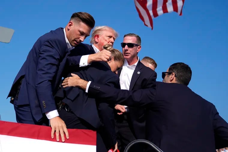 Republican presidential candidate former President Donald Trump is surrounded by U.S. Secret Service agents.