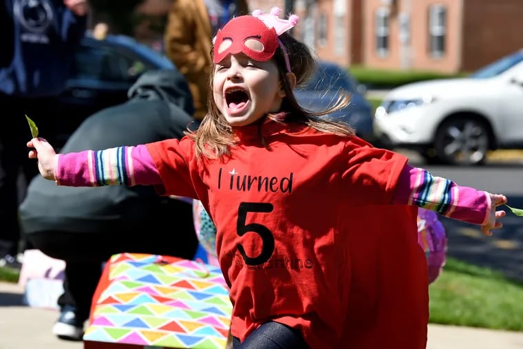 Mackenzie Sahm celebrates as her family and friends drive by in a birthday parade as she turned five April 22, 2020 during the coronavirus shelter-in-place order.