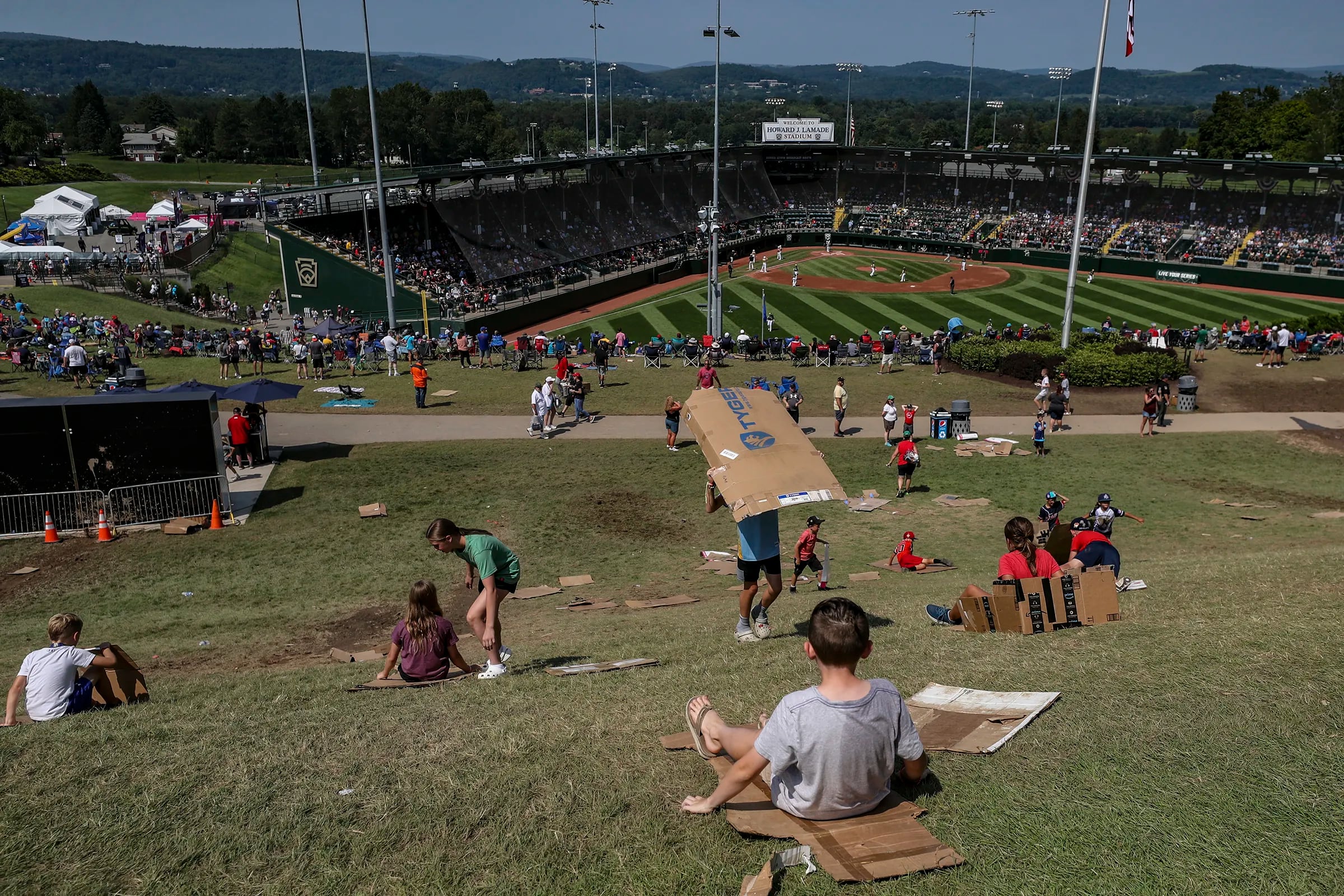 The tradition of sliding down the hill near Lamade Stadium is alive and well during the Little League World Series in 2023. 