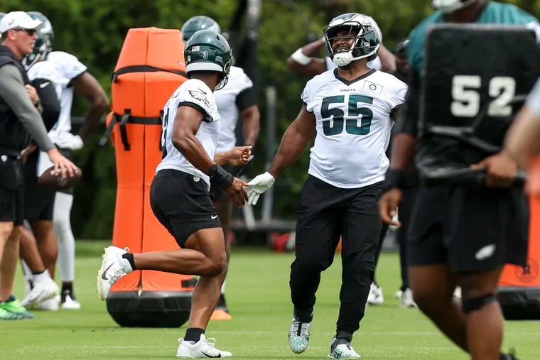 Eagles linebacker Nolan Smith and defensive end Brandon Graham interact during minicamp at the NovaCare Complex in Philadelphia on Wednesday, June 5, 2024.