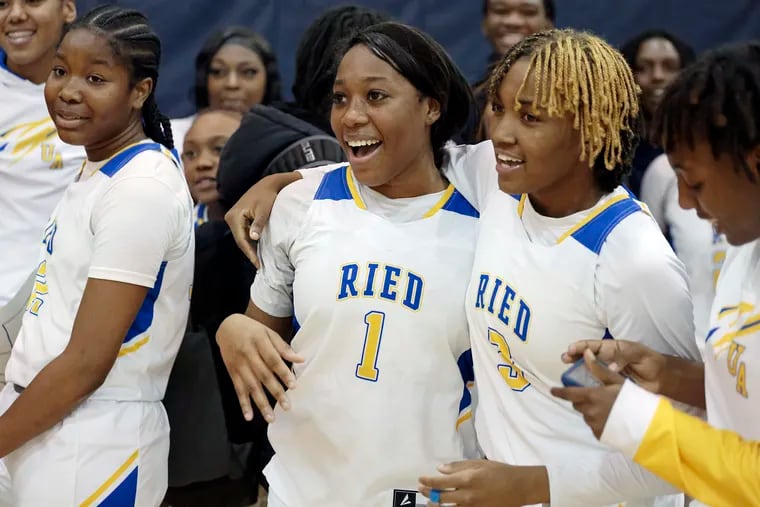 Audenried’s Senaya Parker (1) is surrounded by teammates after scoring her 1,000th point during a home game against Mastery North on Wednesday.