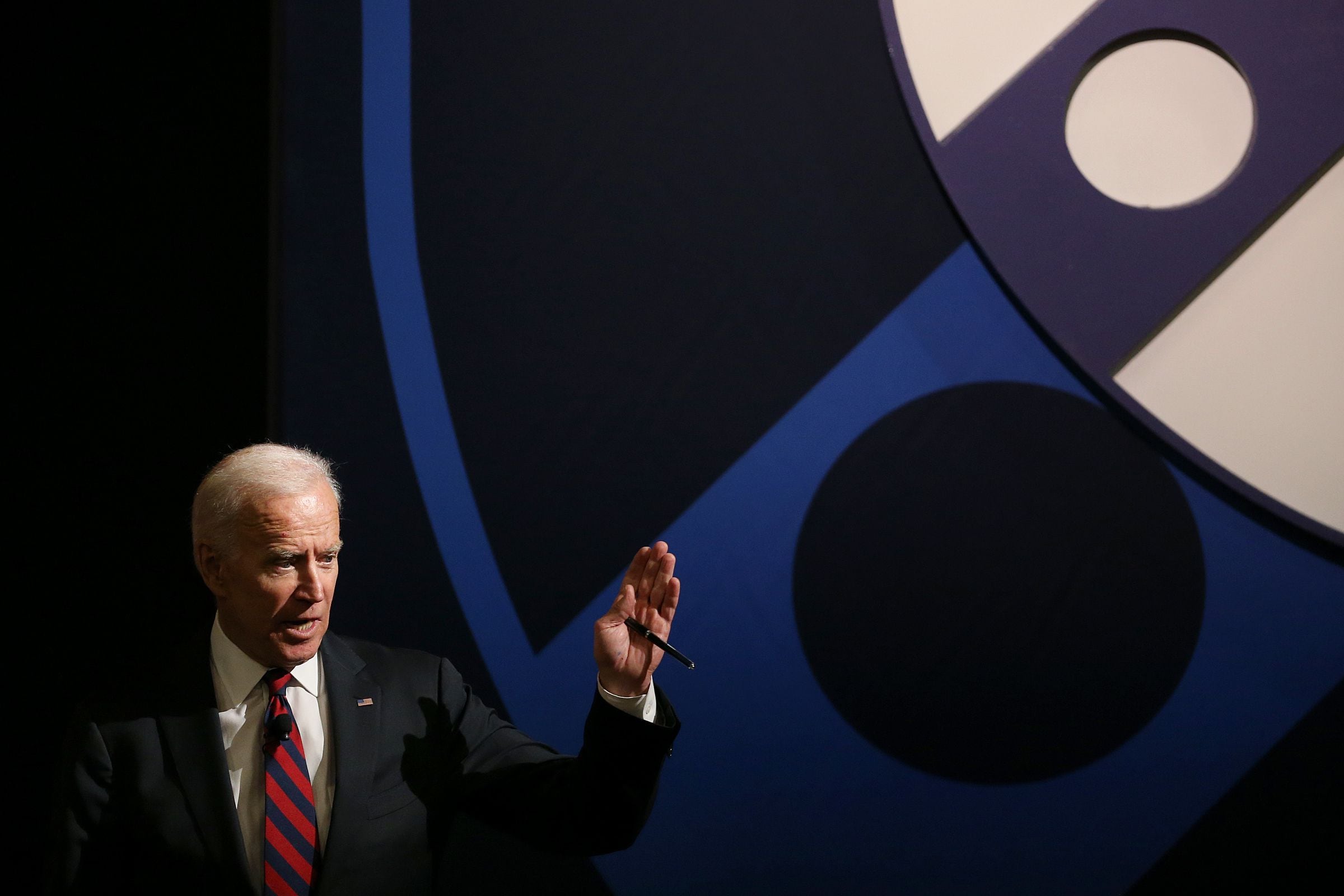 U.S. President Joe Biden holds up a jersey presented to him by