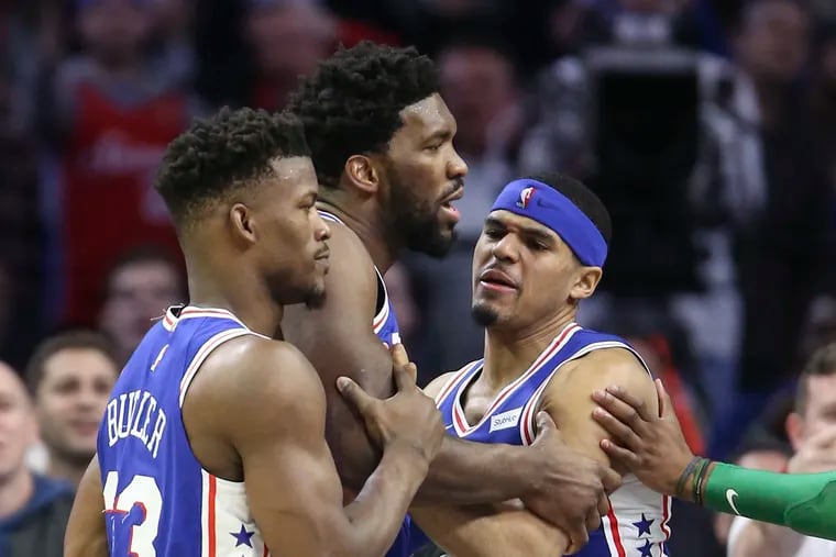 Joel Embiid is held back by teammates after an altercation with the Celtics' Marcus Smart, who was ejected during the third quarter on Wednesday.