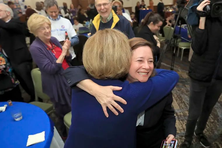 Candidate for the 94th District, Shelly Simonds, celebrates with supporters as election results begin to come in .