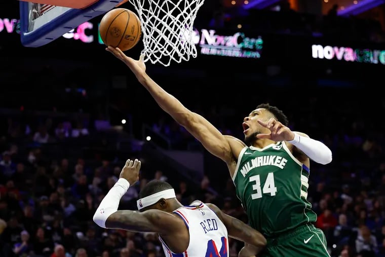 Bucks forward Giannis Antetokounmpo lays-up the basketball over Sixers forward Paul Reed during third quarter.