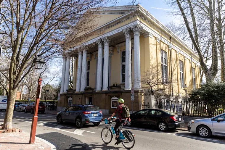 A cyclist rides by the Old Pine Street Presbyterian Church in Society Hill in March 2023.