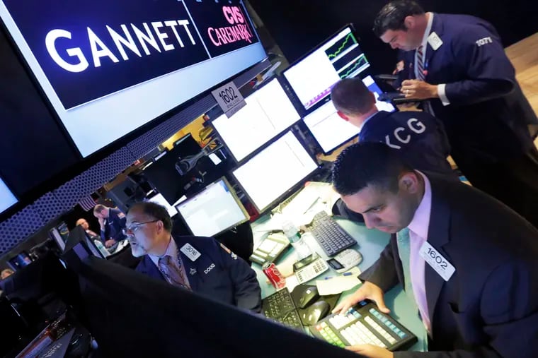 New Media Investment Group Inc. agreed to acquire Gannett Co. in a $1.38 billion deal that unites the two biggest U.S. daily newspaper chains. This photo shows the floor of the New York Stock Exchange in 2014. (AP Photo/Richard Drew, File)