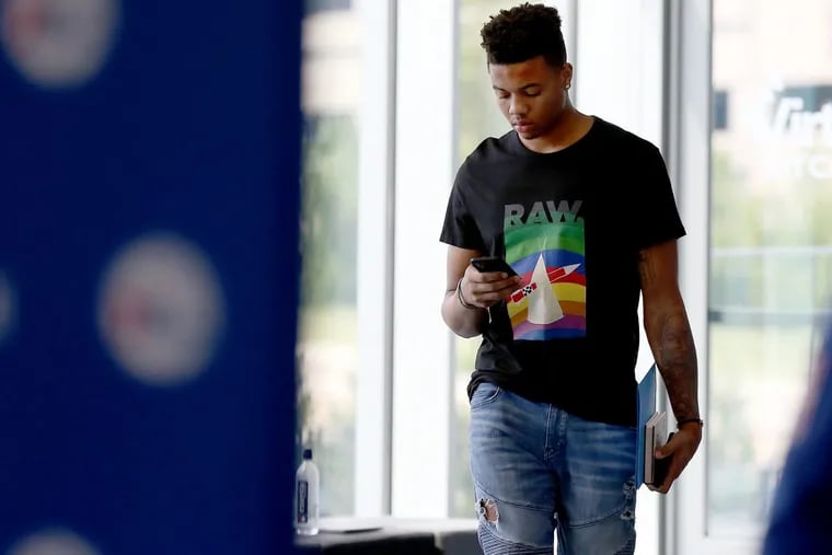 Markelle Fultz checks his phone before he talks to reporters at the Sixers’ practice facility in Camden.