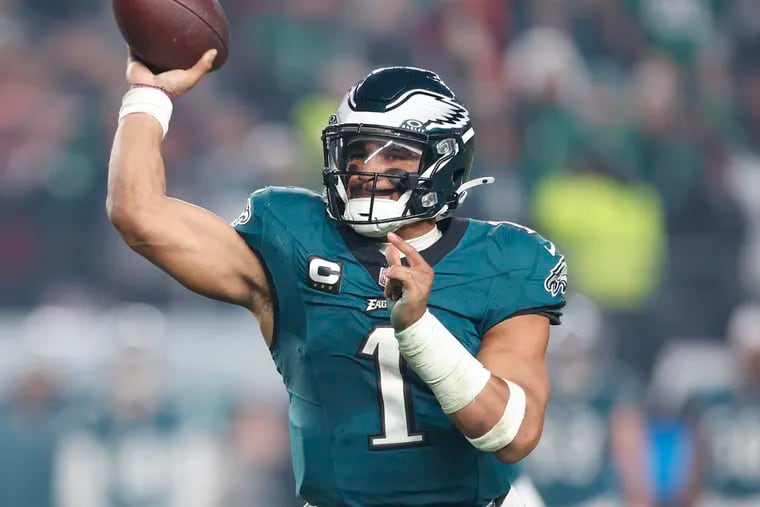 Jalen Hurts and the Eagles moved into first place in the NFC East and clinched a playoff spot Sunday, despite not taking the field until Monday night.
