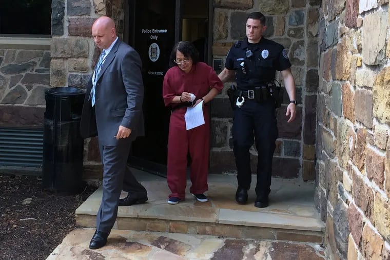 Hsiu-Chin “Linda” Lin leaving court Wednesday after a judge ordered her held for trial on charges of
first-degree murder and other counts in the killing of her ex-husband last week.