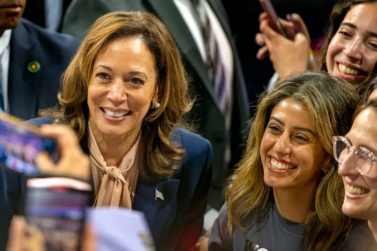 Vice President Kamala Harris poses for photos as she greets supporters following a campaign event with her running mate, Minnesota Gov. Tim Walz, at Temple University's Liacouras Center Tuesday, Aug. 6, 2024.