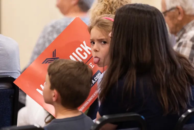 A young girl sticks her tongue out at members of the media at an event for Dave McCormick, Republican candidate for the Senate, at a GOP event at the Bucks County Republican Committee in Doylestown.