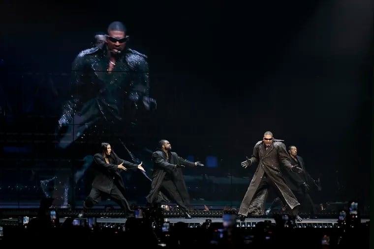 Usher performs during the first night of his two-night USHER: Past, Present, Future Tour stop at the Wells Fargo Center in Philadelphia on Friday.