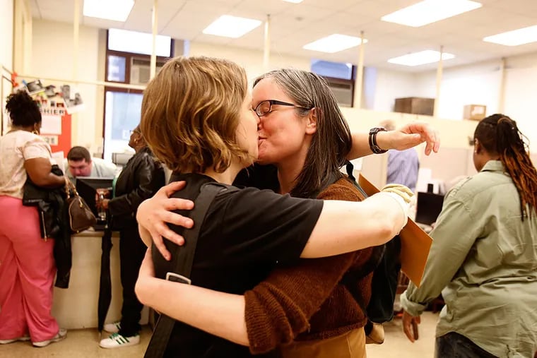 The morning after a judge struck down Pennsylvania's ban on same-sex marriage, couples began the process of getting a marriage license from the Register of Wills at Philadelphia's City Hall. Here, Emily Gavin and Eliza Callard kiss after getting their marriage license this morning.