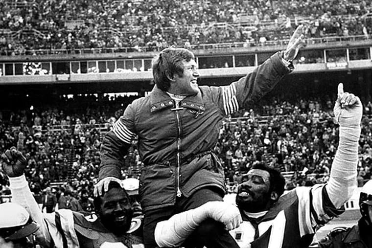 Dick Vermeil is carried off the field by his players after a win.