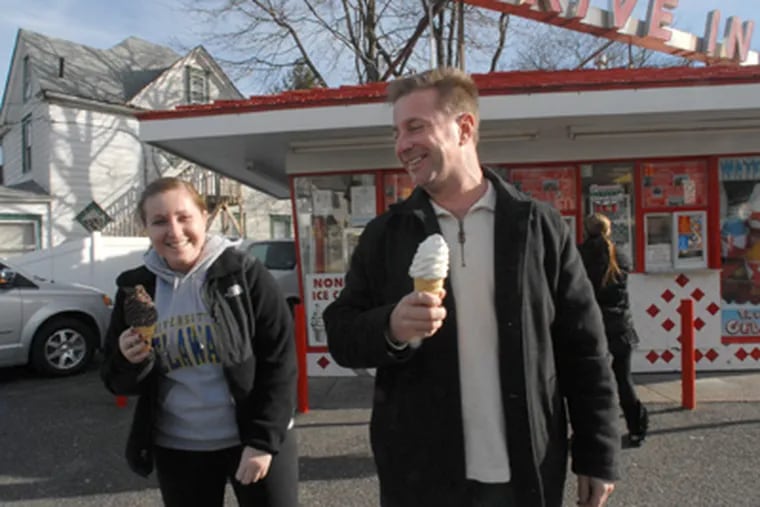 Tom Olbrich and his daughter Nicole, 18, of Moorestown, with their cones at the Maple Shade Custard Stand. (April Saul / Staff Photographer)