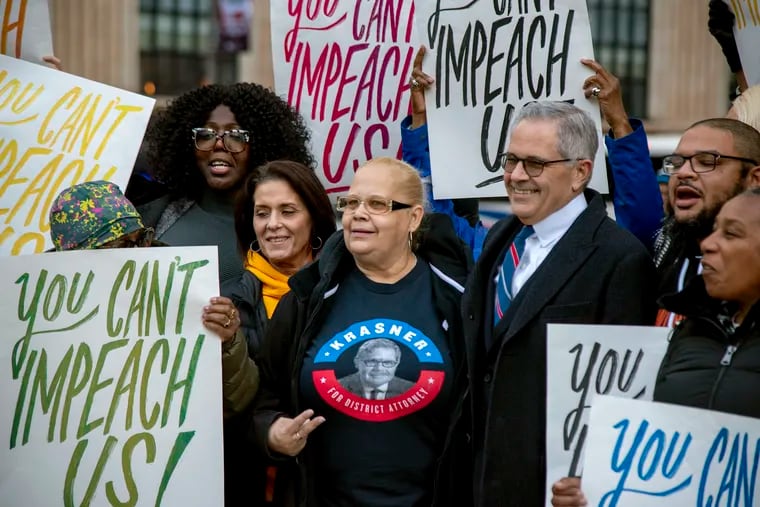 Philadelphia District Attorney Larry Krasner, (right), who was impeached last week by the Pennsylvania state House, is joined by supporters and political allies outside City Hall on Monday. They denounced the charges against him as a Republican-led effort to disenfranchise city voters.