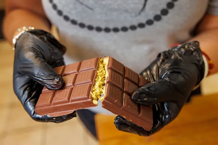 Alexandra Benas with the Cake Boutique in Mullica Hill, NJ cracking apart one of the Dubai chocolate bar. She started making them at request of her brother. It turned into a popular product with TikTok following. Photograph taken at the Cake Boutique on Tuesday, July 30, 2024.