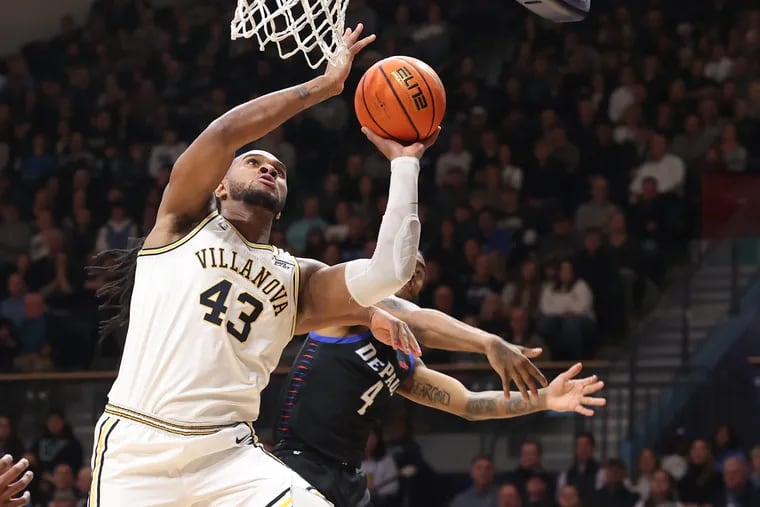 Villanova's Eric Dixon scores against DePaul's Churchill Abass last season. Dixon tested the NBA draft waters before returning to the Wildcats.