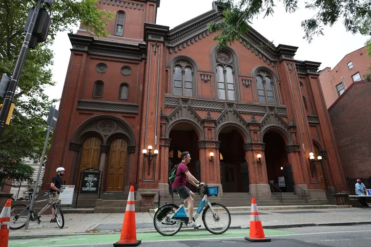 A cyclists rides by the Tenth Presbyterian Church during the weekly protest held by Philly Bike Action in Philadelphia last Sunday.