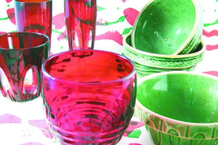 Vintage green-glazed stoneware is perfect for casual holiday parties along with red glasses and silk-screened Sixties fabric.