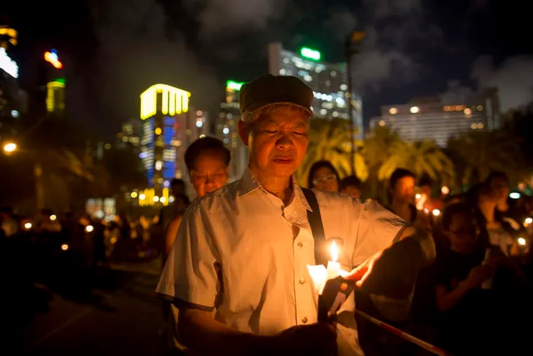 A demonstrator attends a vigil in Hong Kong. The gathering there to mark the 25th anniversary of the Tiananmen Square crackdown was believed to be one of the largest of recent years.