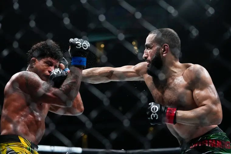 Belal Muhammad, right, punches Brazil's Gilbert Burns during the fourth round of a welterweight bout at the UFC 288 mixed martial arts event Sunday, May 7, 2023, in Newark, N.J. Muhammad won the fight. (AP Photo/Frank Franklin II)