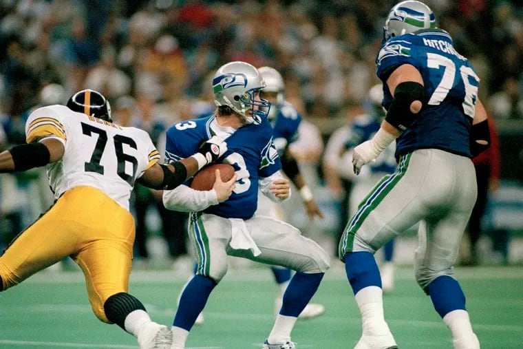 Seattle Seahawks quarterback Rick Mirer (3) was sacked by Kevin Henry (76) of the Pittsburgh Steelers during an NFL game on Dec. 26, 1993. Dementia tests in the NFL concussion litigation allow doctors to use different baseline standards for Black and white retired players, making it more difficult for Blacks to show injury and qualify for awards, lawyers for two ex-players argued in court filings last August. Lawyers for ex-players Henry and Najeh Davenport said their clients were denied awards “based on a discriminatory testing regime" that weighs sociological factors including race. Both men would have qualified for awards had race not been considered, they said.