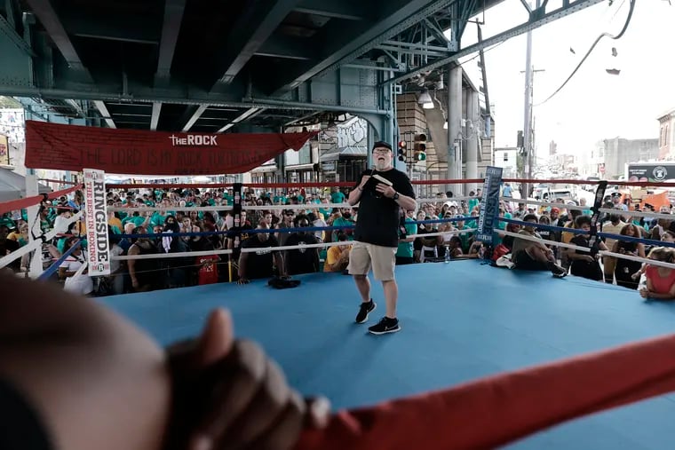 From a boxing ring in the middle of Kensington Avenue, Rock Ministries pastor and founder Mark "Buddy" Osborn calls for people to find God during The Rock Ministries annual "Rock the Block" block party on Kensington Avenue on Aug. 10.