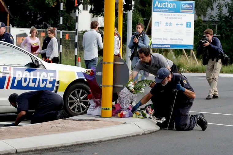 Police officers search the area near the Masjid Al Noor mosque, site of one of the mass shootings at two mosques in Christchurch, New Zealand, Saturday, March 16, 2019.