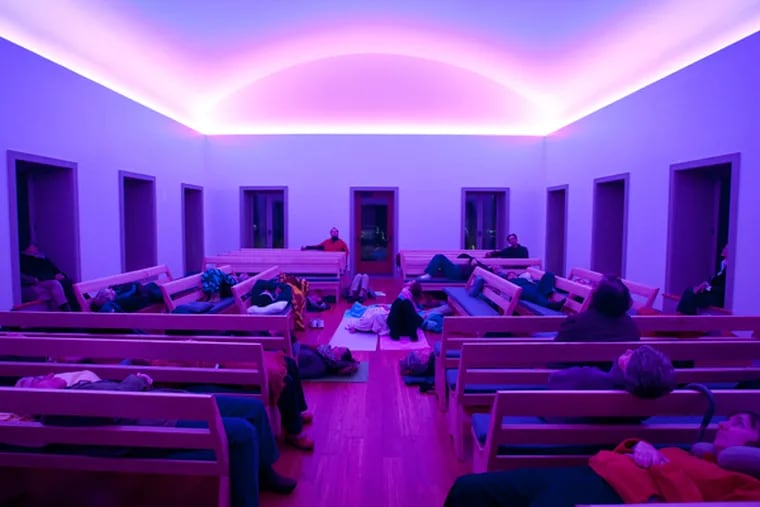 People watch an art light installation by internationally known artist James Turrell at Chestnut Hill Friends Meetinghouse. October 23, 2013 (RON TARVER/Staff Photographer)