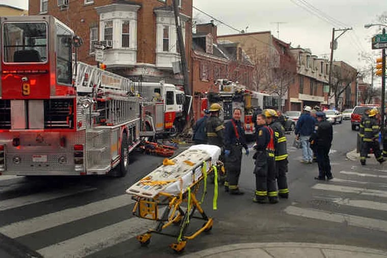 Firefighters and investigators at Eighth and Lombard Streets, where Ladder 9 and Squrt 43 crashed. Nine firefighters and one civilian went to city hospitals. One firefighter was expected to be admitted for observation overnight.