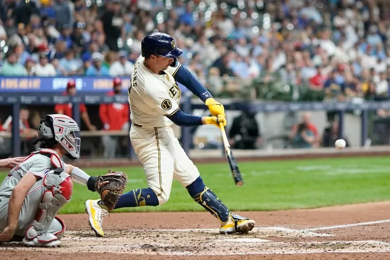 The Brewers' Rhys Hoskins hits a home run against Aaron Nola during the fifth inning on Wednesday.