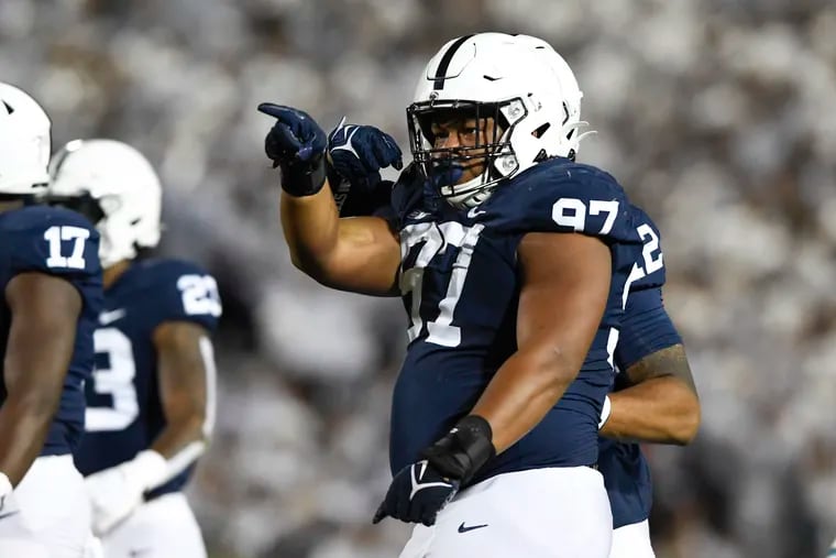 Penn State defensive tackle PJ Mustipher celebrates after a tackle last season.