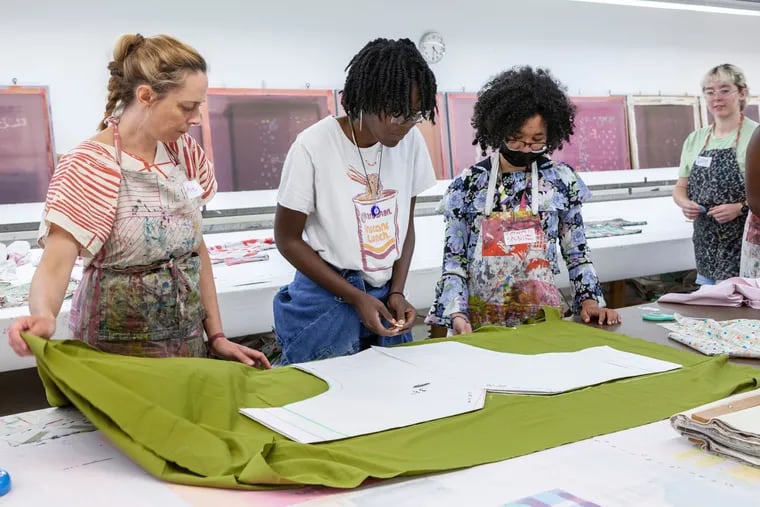 Aeniah Godwin (center) and Saoni Lorenzo (right) participate in a sewing workshop at the Fabric Workshop and Museum in Philadelphia, where they were interns for the summer through the Greater Philadelphia Cultural Alliance's Bloomberg Arts Internship.
