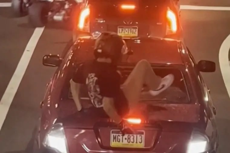 This image shows Cody Heron smashing a car’s back window on Oct. 1, 2023, in Philadelphia.