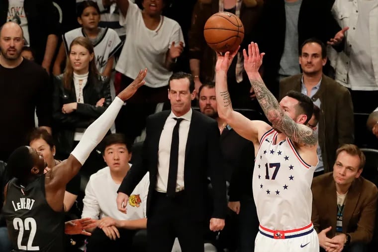 Sixers guard JJ Redick shoots a three-point basket past Brooklyn Nets guard Caris LeVert late in game four of the Eastern Conference playoffs on Saturday, April 20, 2019 in Brooklyn.  Redick made the basket.