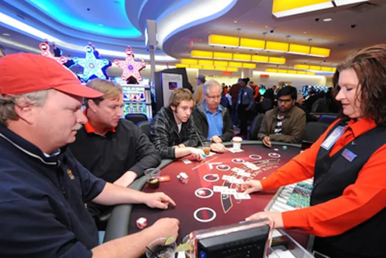Michael Lee (left), 49, and his buddy Johnny Mac, 47, both from Wayne, play blackjack at a $15 minimum table at the newly opened Valley Forge Casino Resort at the Valley Forge Convention Center in King of Prussia Saturday, March 31, 2012.  ( Clem Murray / Staff Photographer )
