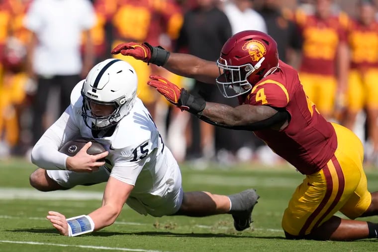 Penn State quarterback Drew Allar (15) lunges past Southern California linebacker Easton Mascarenas-Arnold (4) during the first half of their Big Ten matchup in Los Angeles on Saturday.