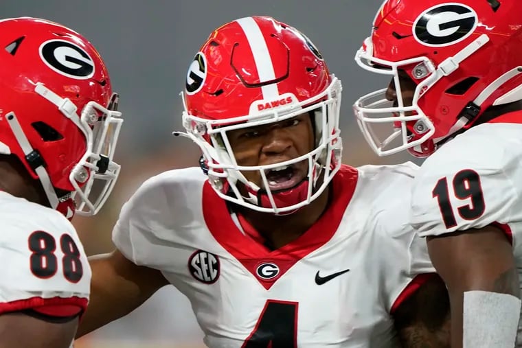 Georgia linebacker Nolan Smith, center, celebrates after sacking Clemson quarterback D.J. Uiagalelei during the first half of an NCAA college football game Saturday, Sept. 4, 2021, in Charlotte, N.C.