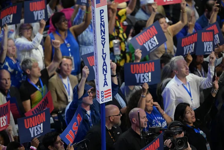 Pennsylvania Delegates wave their signs Monday at the start of the 2024 Democratic National Convention in Chicago.