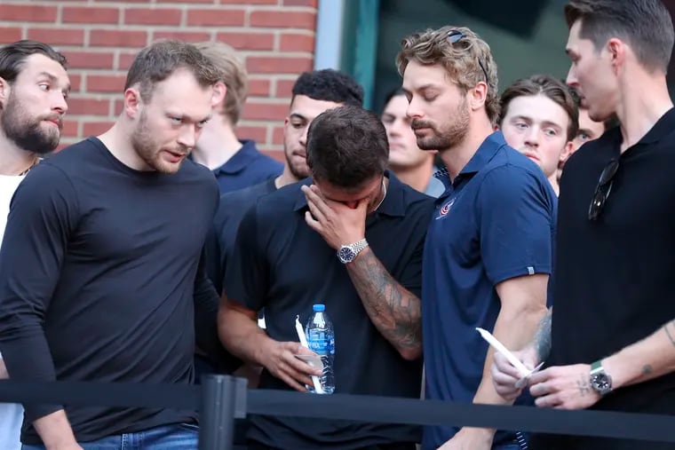 Columbus Blue Jackets players mourn the death of former teammate Johnny Gaudreau at Wednesday's vigil.