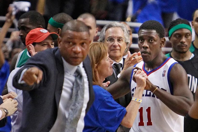 Jrue Holiday celebrates with fans as former Celtics coach Doc Rivers acknowledges the Sixers' coaching staff after a Sixers Eastern Conference semifinal win in 2012.