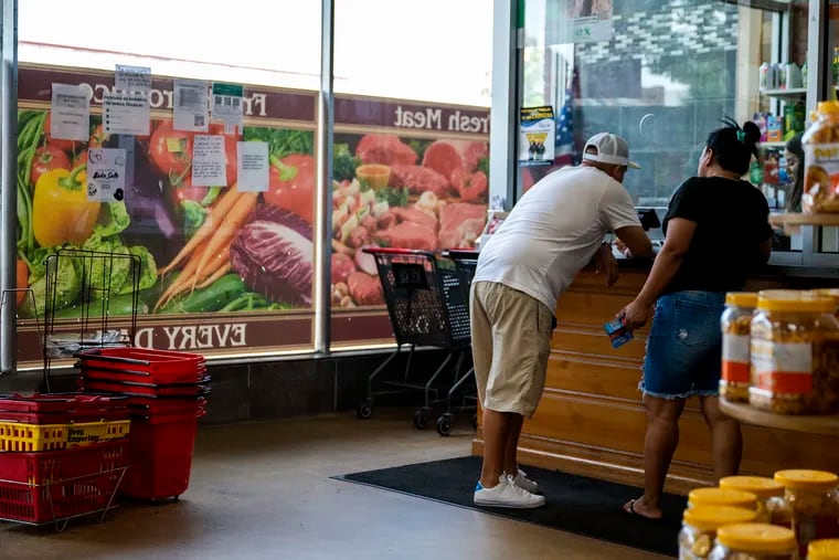 Consumers at the counter at the Meat Shoppers Supermarket in Riverside, N.J., last month. Wednesday's Consumer Price Index report provided promising signs that inflation is cooling, but Temple professor Wayne W. Williams said, "It doesn't mean spend more."