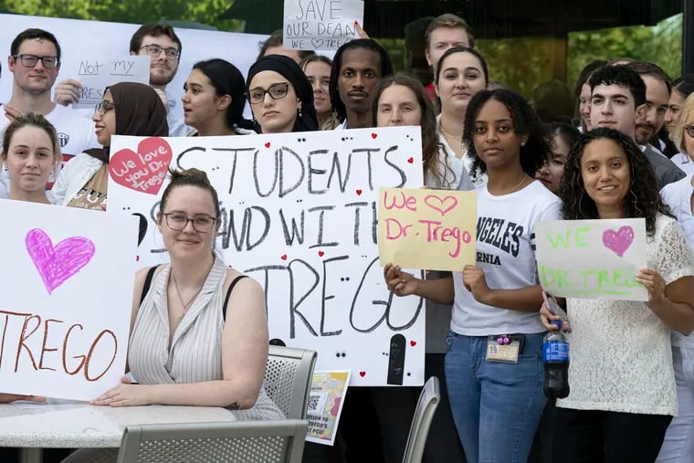 Optometry students hold signs on Friday in support for their Dean Melissa Trego during a rally at Salus University in Elkins Park. The leadership of Salus has removed the dean as the university works to implement its merger with Drexel University.